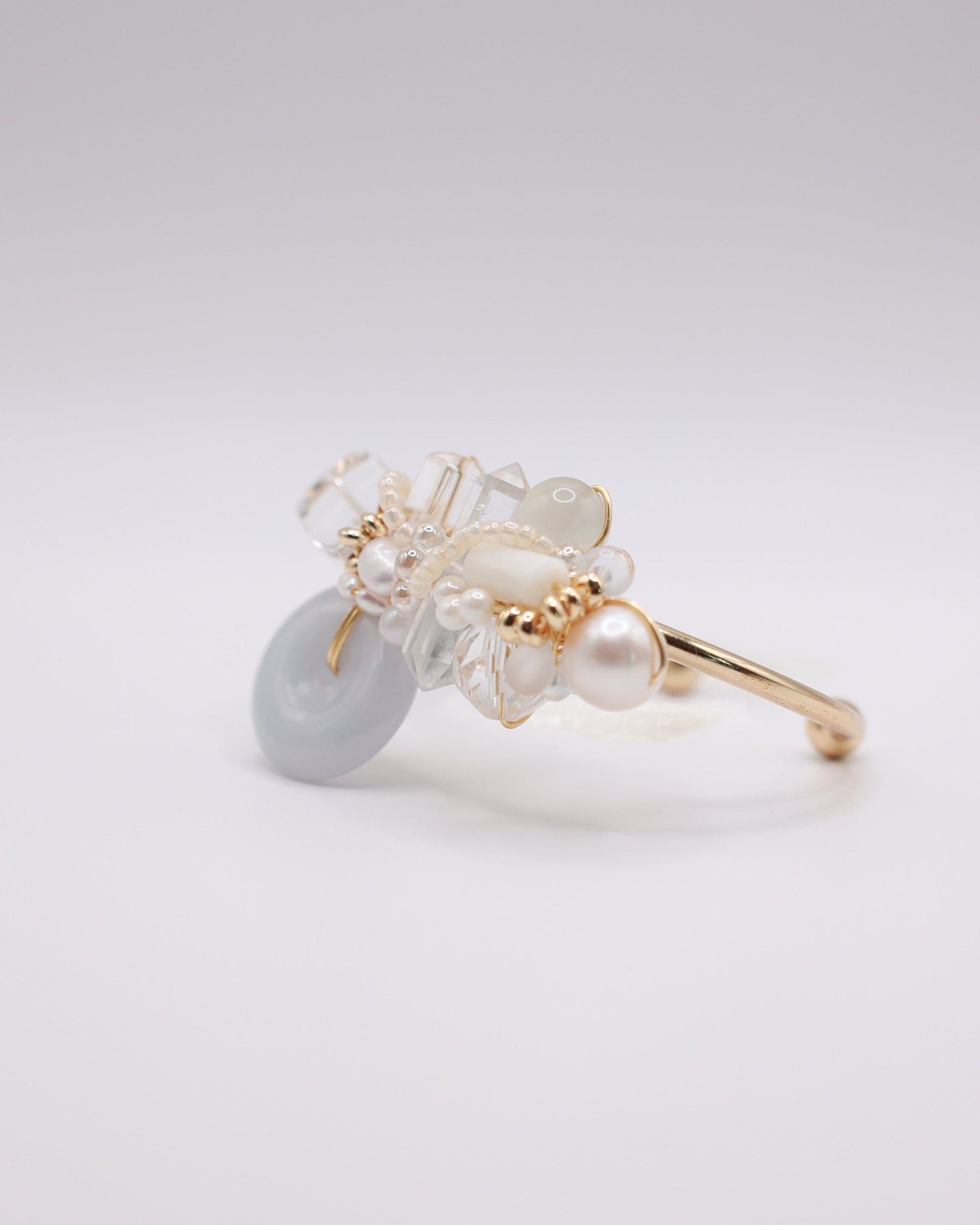 Jade donut bangle with crystal elements on gold cuff bangle